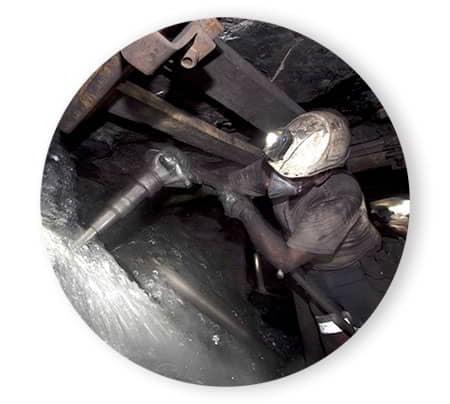 Miner cutting coal in the mine