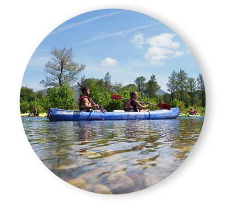 Two people in a canoe descending a river.